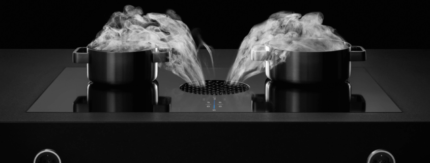 Bilde av BORA_X-Pure_benkeventilator hvor du ser at dampen forsvinner ned i ventilatoråpningen fra 2 gryter som koker